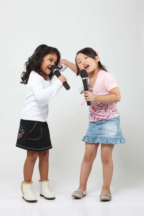 girls singing microphone against white background